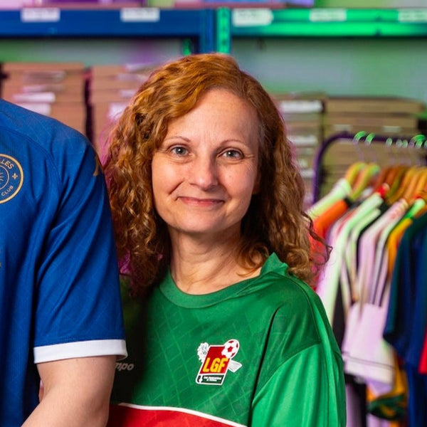 Kellie smiles at the camera, wearing a green Guadeloupe shirt